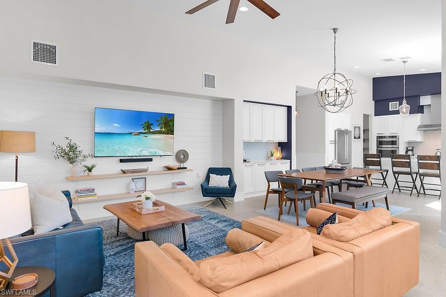 255 Columbus Way Marco Island, FL 34145 - Photo 13 of 50 a living room with furniture a chandelier and a flat screen tv