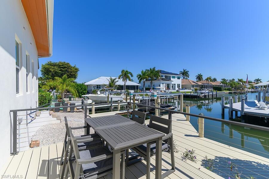 255 Columbus Way Marco Island, FL 34145 - Photo 16 of 50 a terrace with outdoor seating and city view