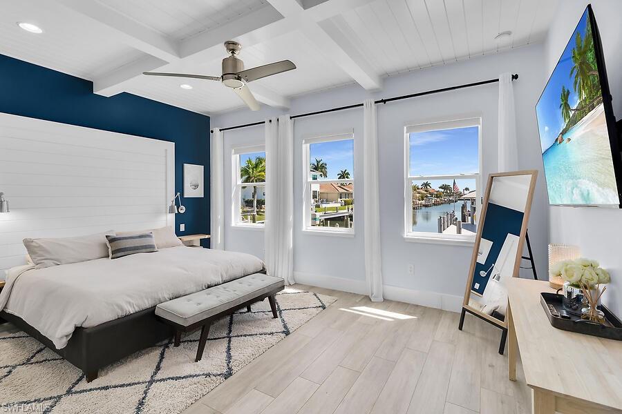 255 Columbus Way Marco Island, FL 34145 - Photo 19 of 50 a bedroom with a bed window and a flat screen tv