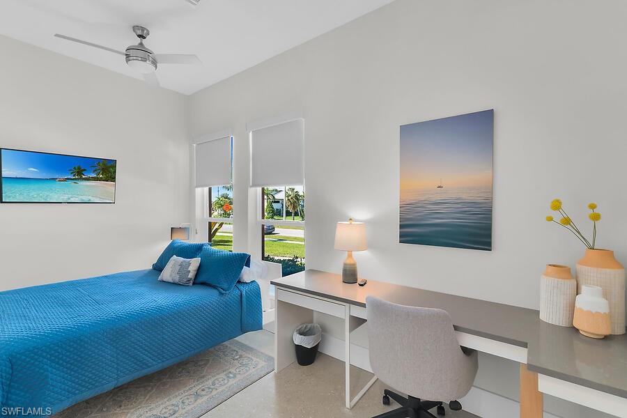 255 Columbus Way Marco Island, FL 34145 - Photo 30 of 50 a bedroom with a bed and a table