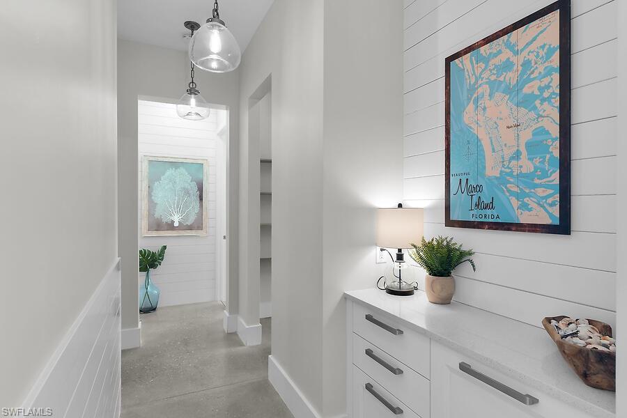 255 Columbus Way Marco Island, FL 34145 - Photo 31 of 50 a view of a hallway with wooden floor and a potted plant