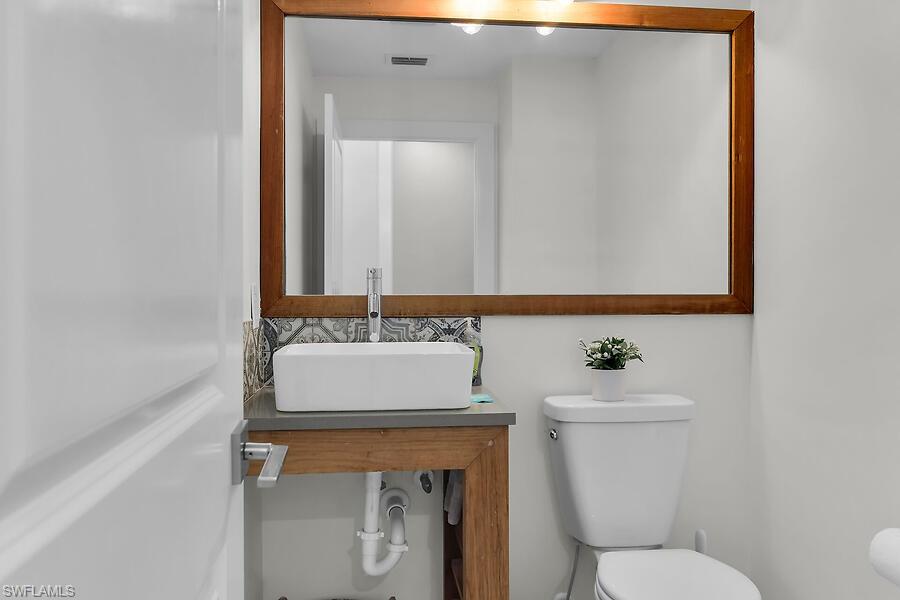 255 Columbus Way Marco Island, FL 34145 - Photo 32 of 50 a bathroom with a sink toilet and mirror