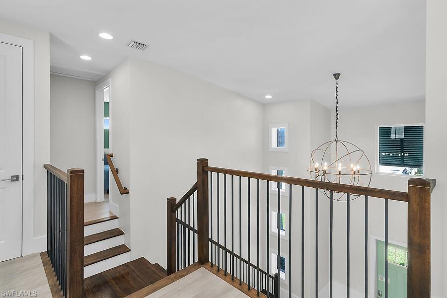 255 Columbus Way Marco Island, FL 34145 - Photo 35 of 50 a view of a hallway with wooden floor and stairs