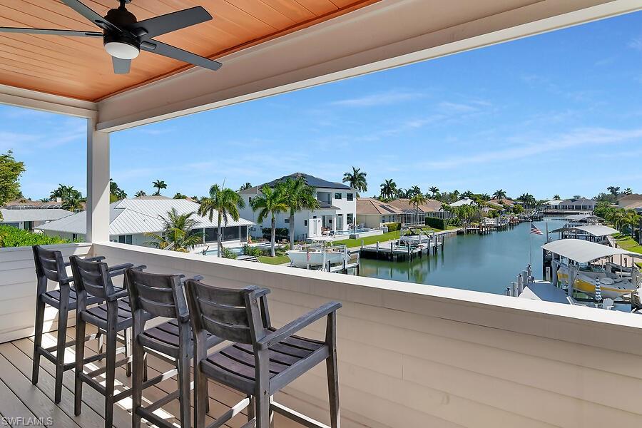 255 Columbus Way Marco Island, FL 34145 - Photo 38 of 50 a view of swimming pool with outdoor seating and lake