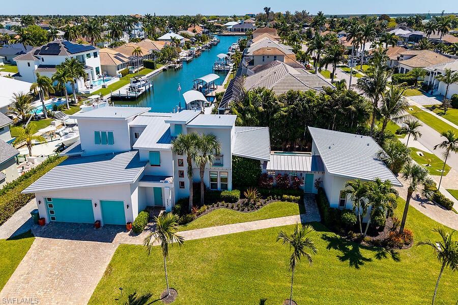 255 Columbus Way Marco Island, FL 34145 - Photo 4 of 50 an aerial view of a house with swimming pool and outdoor seating