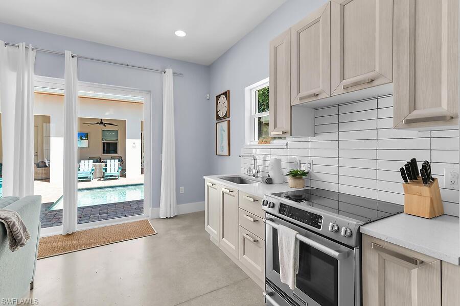 255 Columbus Way Marco Island, FL 34145 - Photo 46 of 50 a kitchen with stainless steel appliances granite countertop a stove and a sink