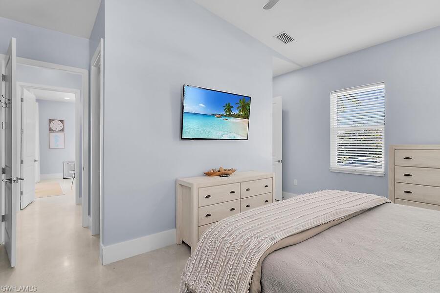 255 Columbus Way Marco Island, FL 34145 - Photo 47 of 50 a bedroom with a bed and a window