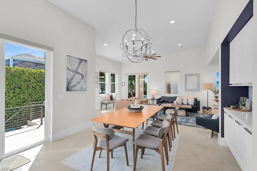 255 Columbus Way Marco Island, FL 34145 - Photo 9 of 50 a view of a dining room with furniture wooden floor and chandelier