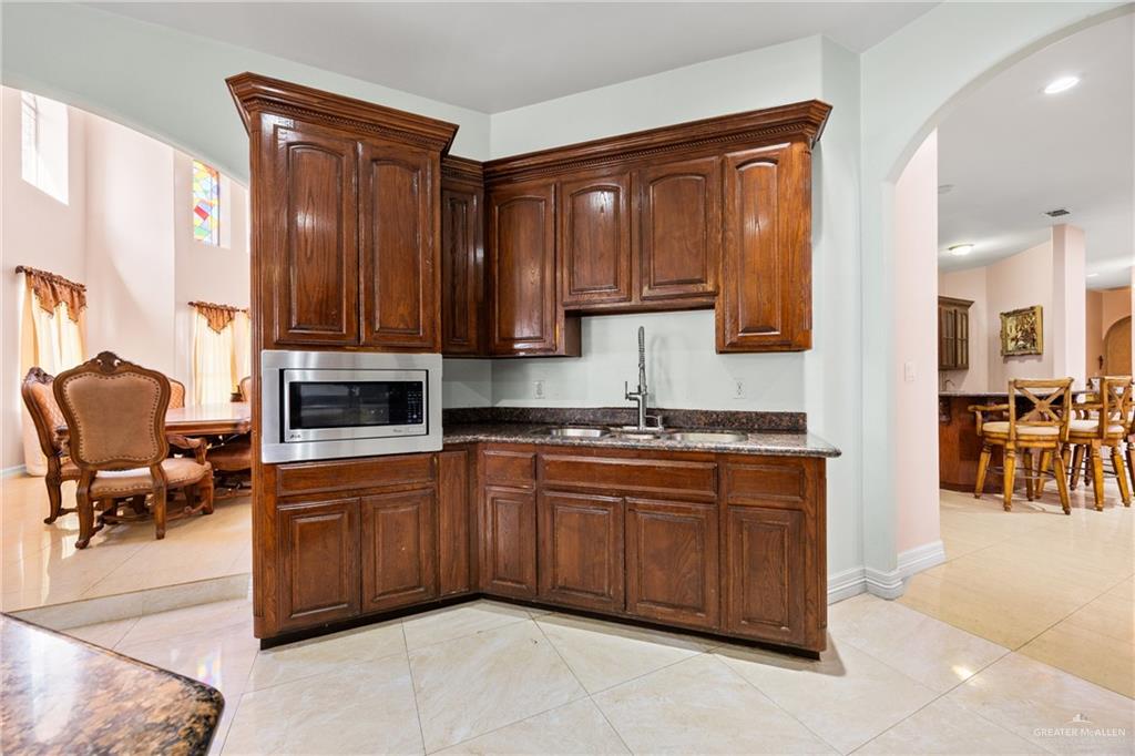 508 El Paisano Road Rio Grande City, TX 78582 - Photo 12 of 42 a kitchen with stainless steel appliances granite countertop a sink and cabinets