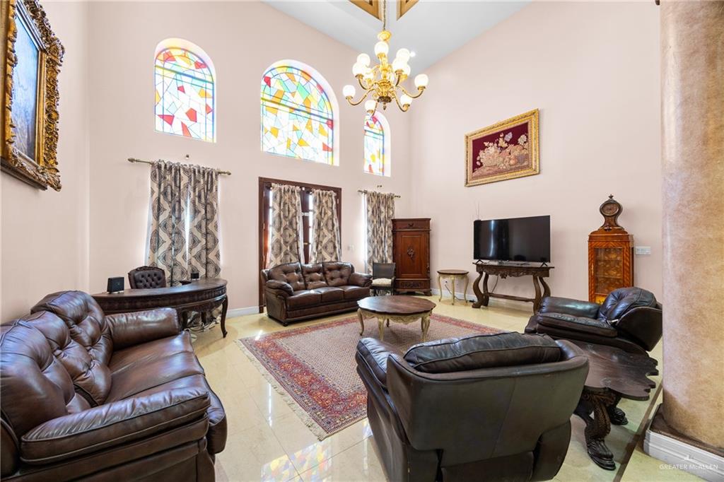 508 El Paisano Road Rio Grande City, TX 78582 - Photo 14 of 42 a living room with furniture a chandelier and a flat screen tv