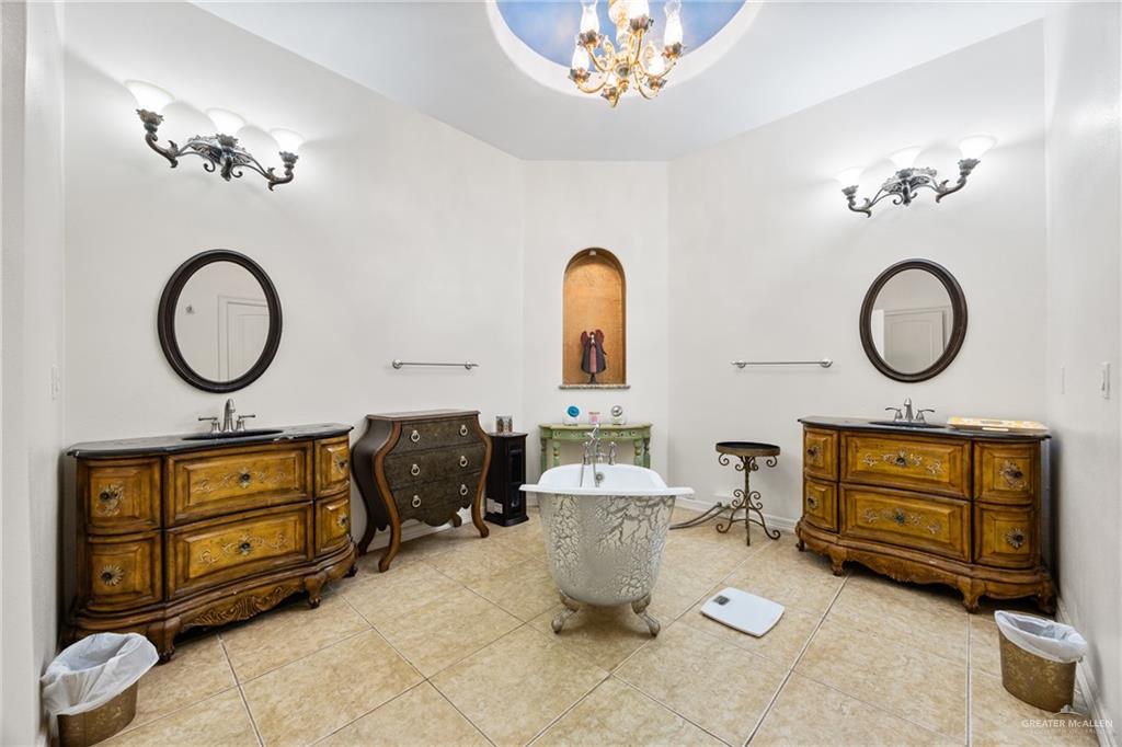 508 El Paisano Road Rio Grande City, TX 78582 - Photo 19 of 42 a living room with furniture a mirror and a chandelier