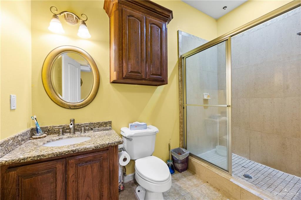 508 El Paisano Road Rio Grande City, TX 78582 - Photo 24 of 42 a bathroom with a granite countertop toilet sink and mirror