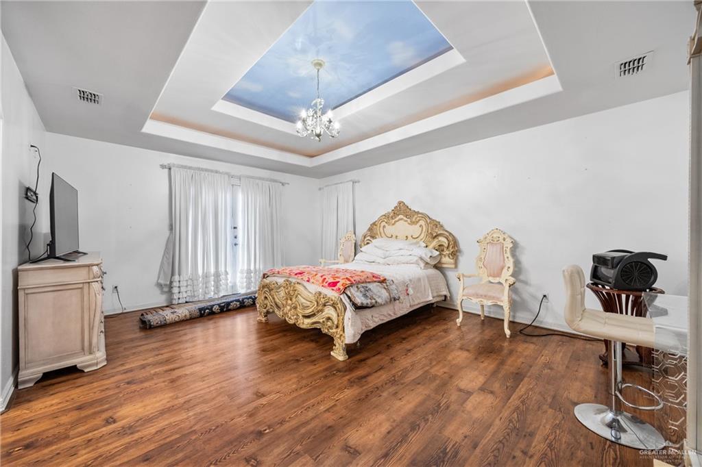 508 El Paisano Road Rio Grande City, TX 78582 - Photo 26 of 42 a spacious bedroom with a bed and wooden floor