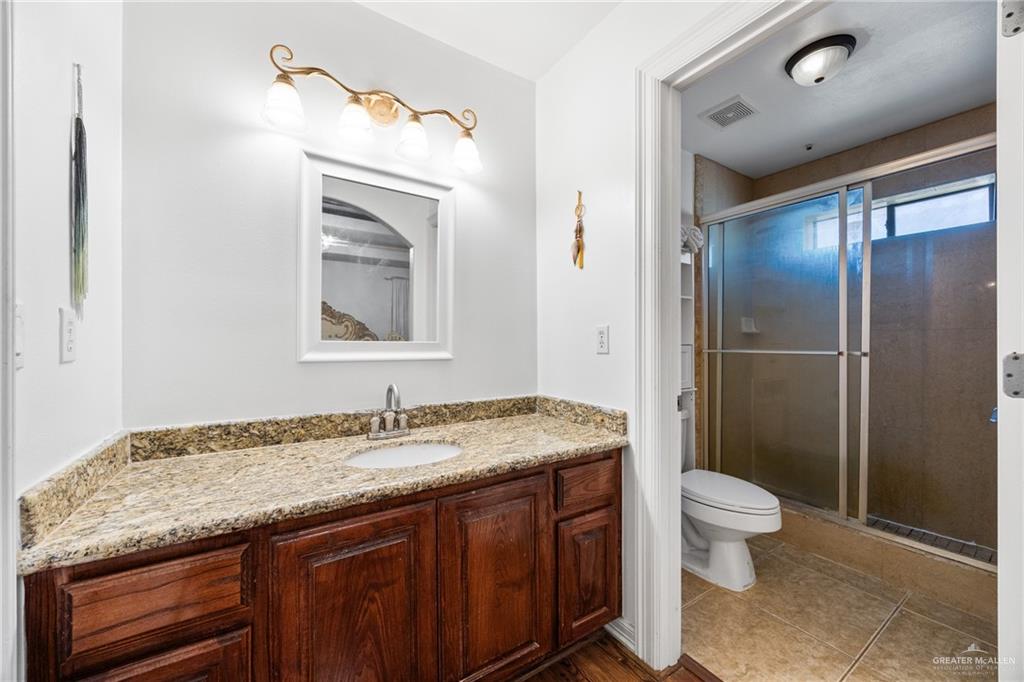 508 El Paisano Road Rio Grande City, TX 78582 - Photo 27 of 42 a bathroom with a granite countertop sink toilet and shower