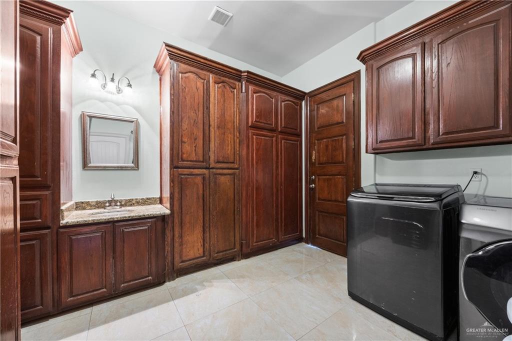 508 El Paisano Road Rio Grande City, TX 78582 - Photo 30 of 42 a kitchen with stainless steel appliances granite countertop a refrigerator and a stove top oven