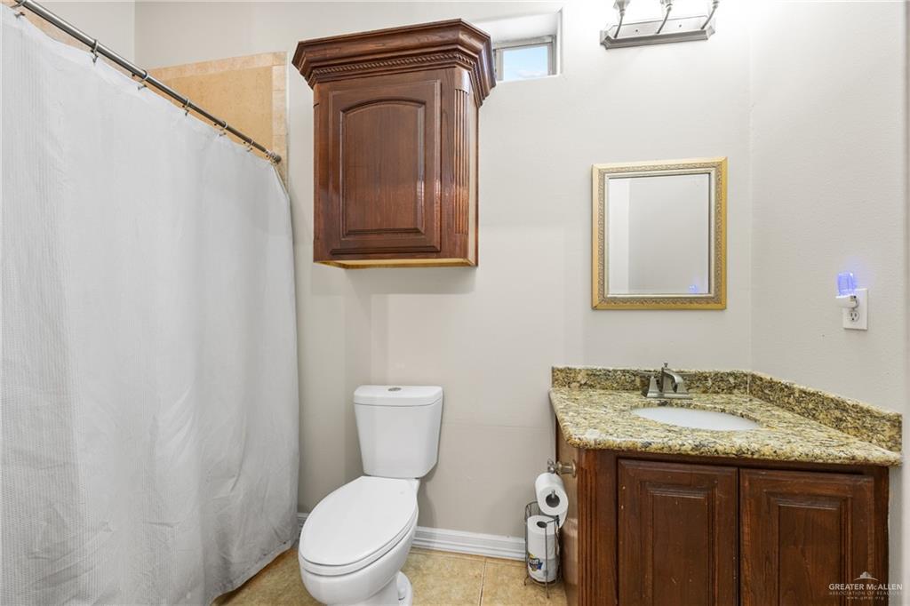 508 El Paisano Road Rio Grande City, TX 78582 - Photo 31 of 42 a bathroom with a granite countertop toilet sink and mirror