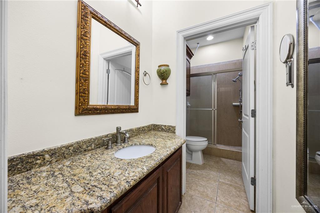 508 El Paisano Road Rio Grande City, TX 78582 - Photo 32 of 42 a bathroom with a granite countertop sink and a mirror