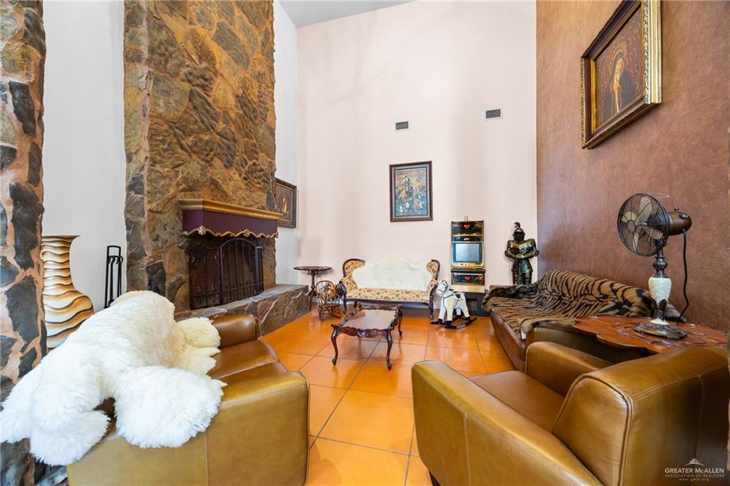 508 El Paisano Road Rio Grande City, TX 78582 - Photo 8 of 42 a living room with furniture a fireplace and a table