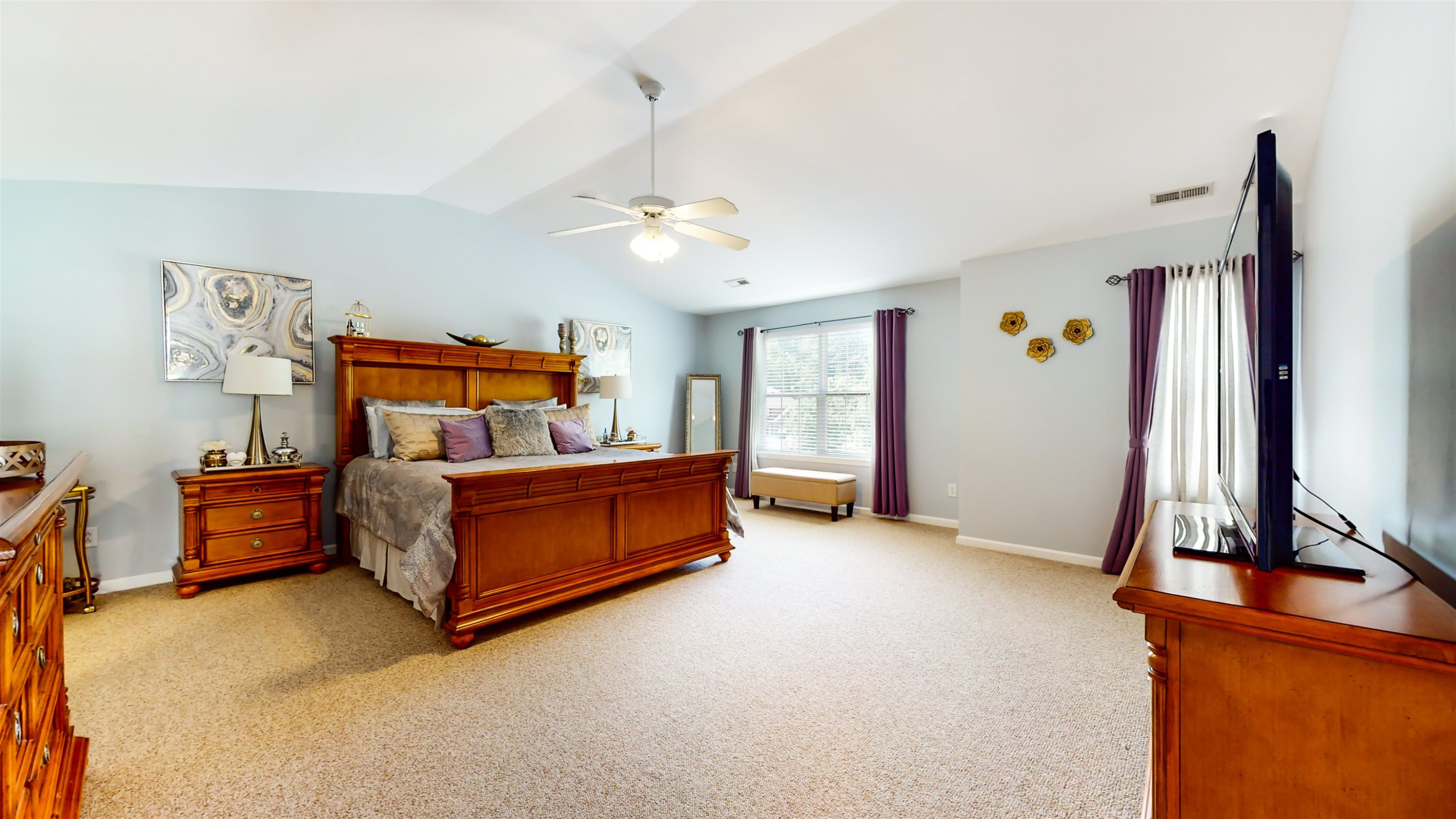 509 Ember Drive Durham, NC 27703 - Photo 13 of 24 a bedroom with a bed and a tv on the dresser