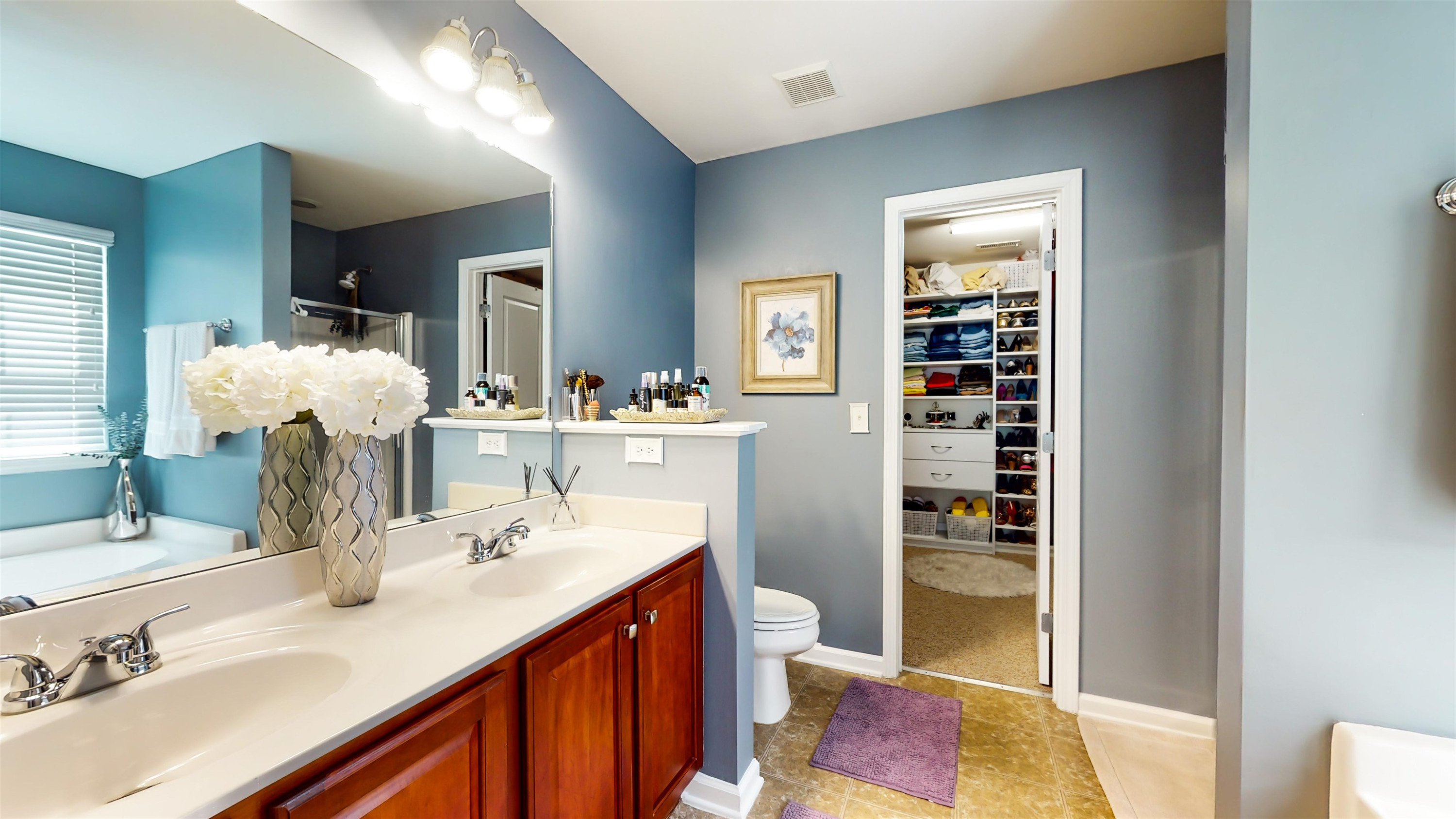 509 Ember Drive Durham, NC 27703 - Photo 15 of 24 a en suite bathroom with a double vanity sink a mirror and a bathtub