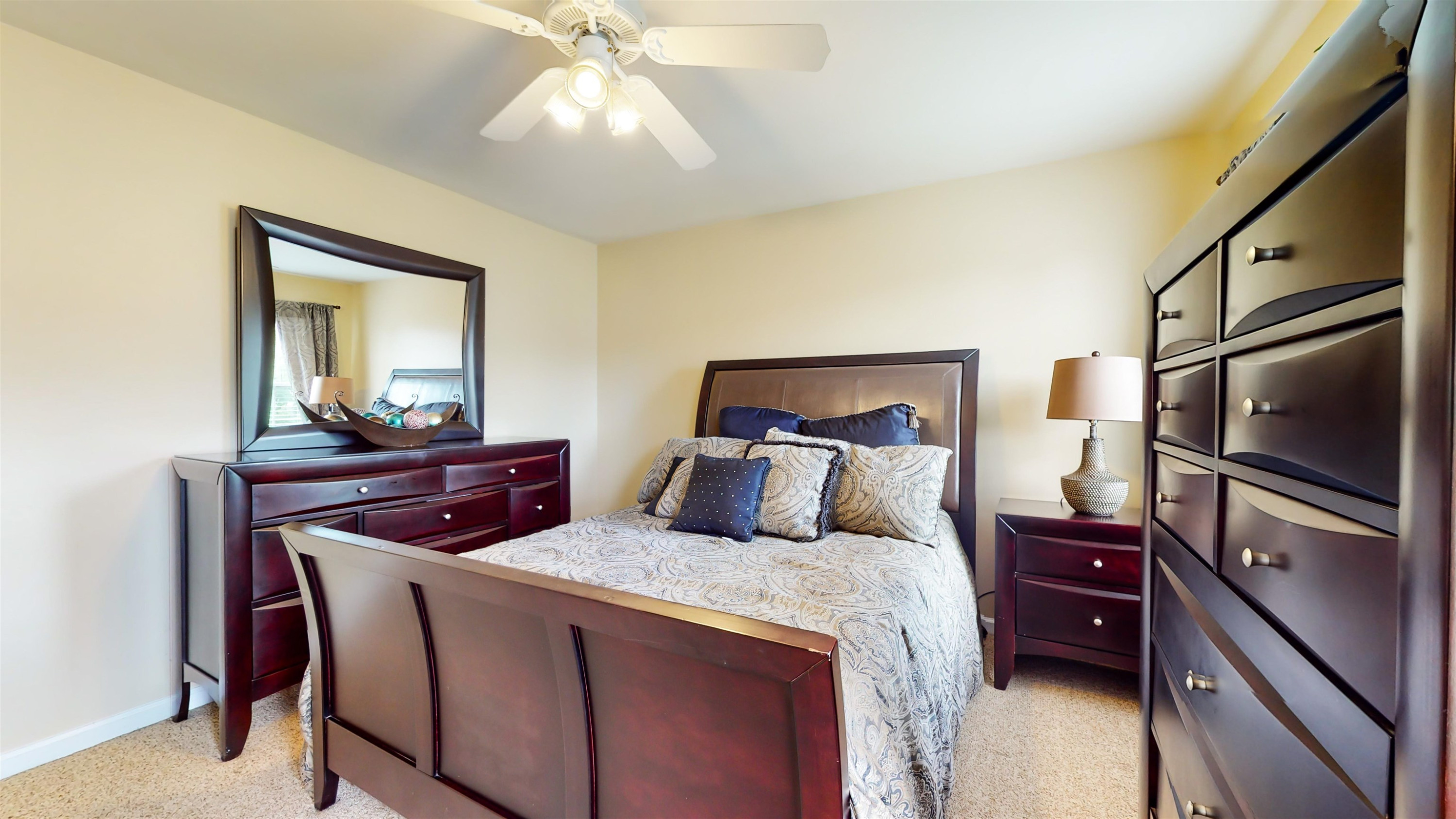 509 Ember Drive Durham, NC 27703 - Photo 18 of 24 a bedroom with a bed and a flat tv screen on dresser