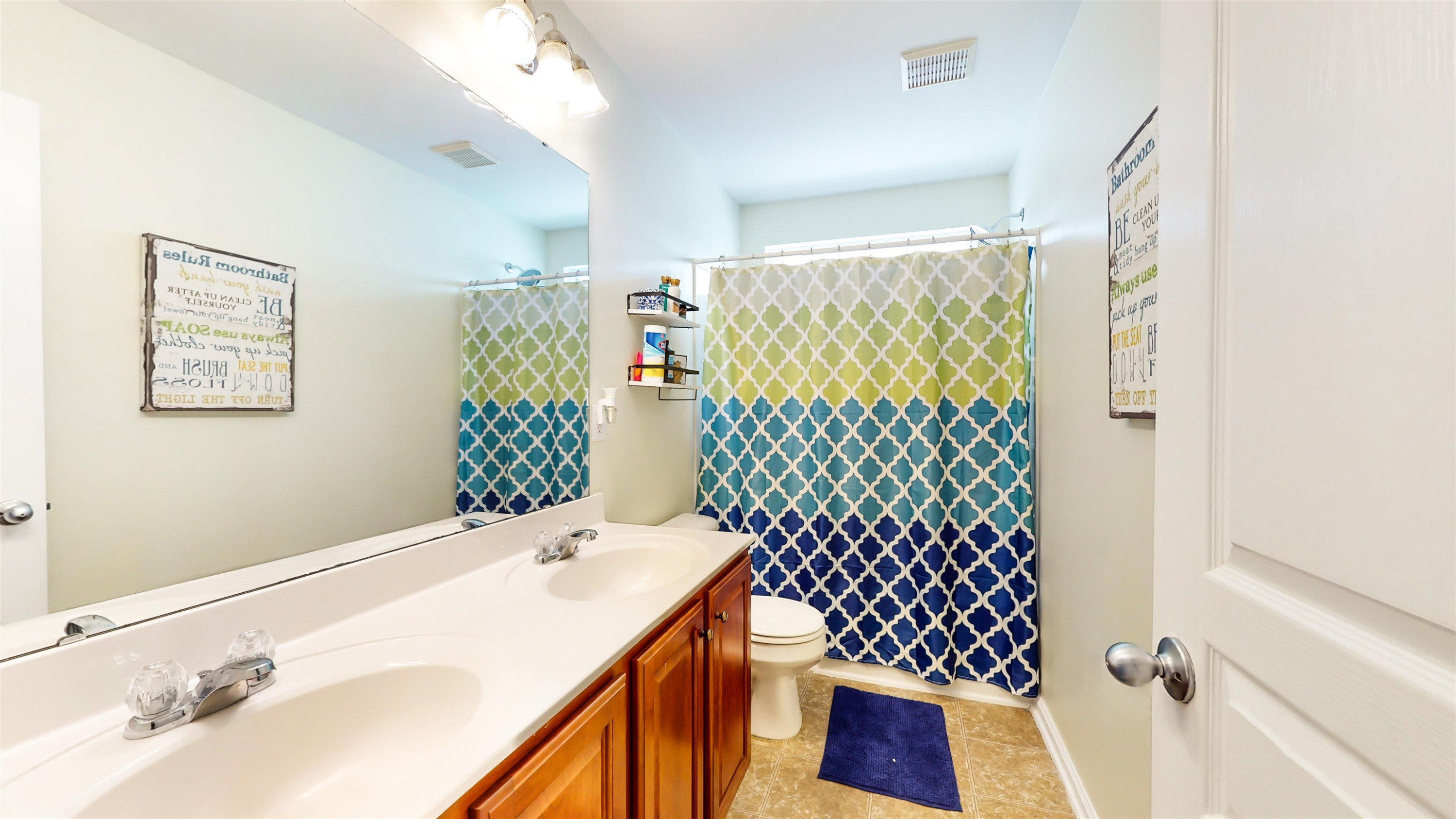 509 Ember Drive Durham, NC 27703 - Photo 19 of 24 a bathroom with a double vanity sink mirror and shower