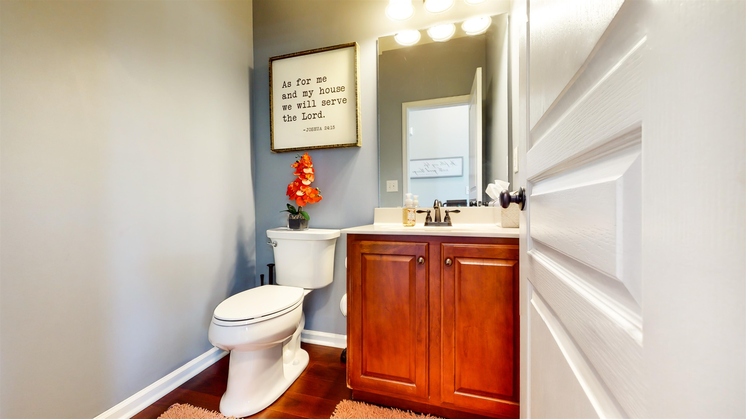 509 Ember Drive Durham, NC 27703 - Photo 6 of 24 a bathroom with a toilet sink and mirror
