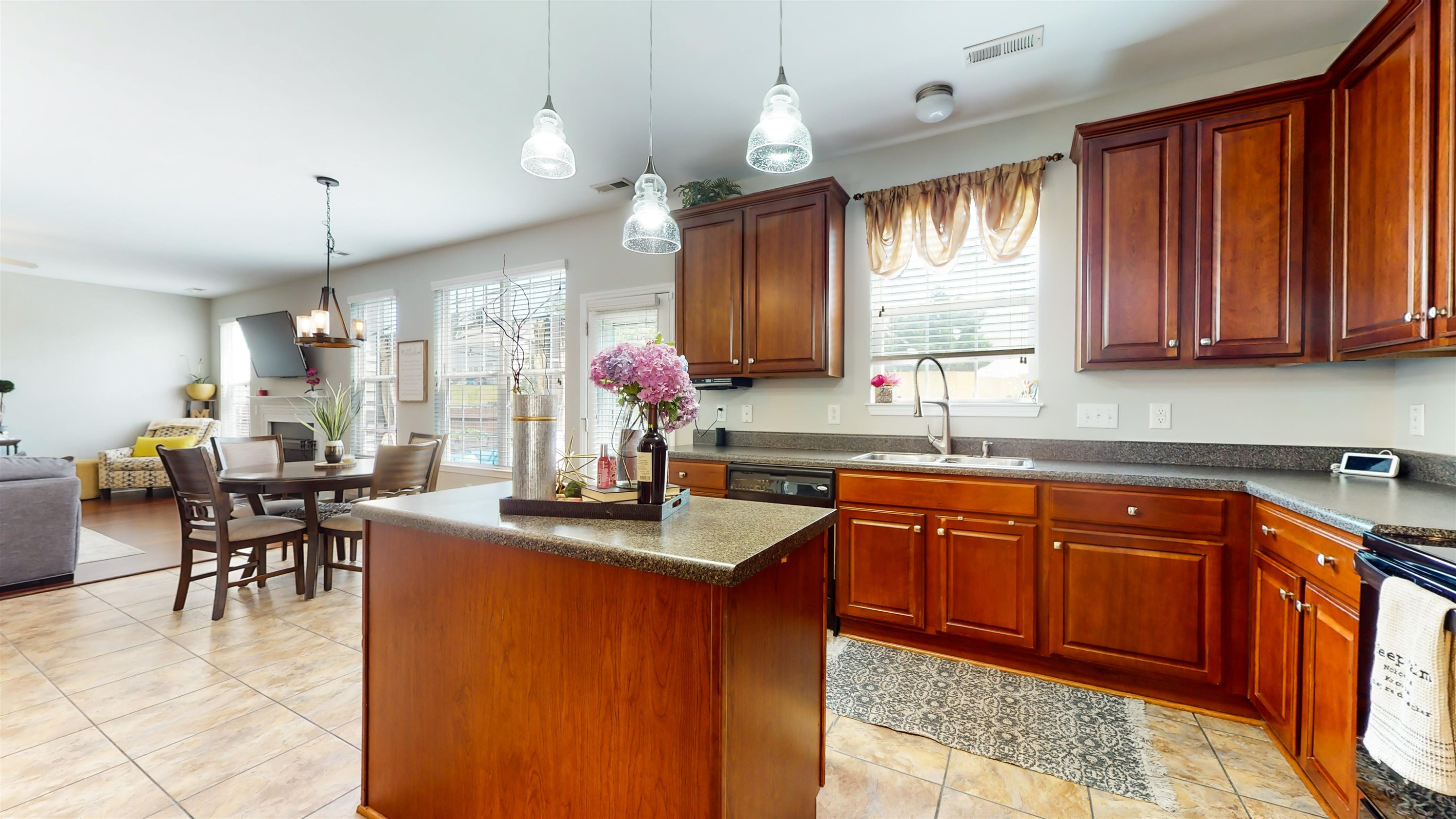 509 Ember Drive Durham, NC 27703 - Photo 8 of 24 a kitchen with granite countertop a sink stove and cabinets