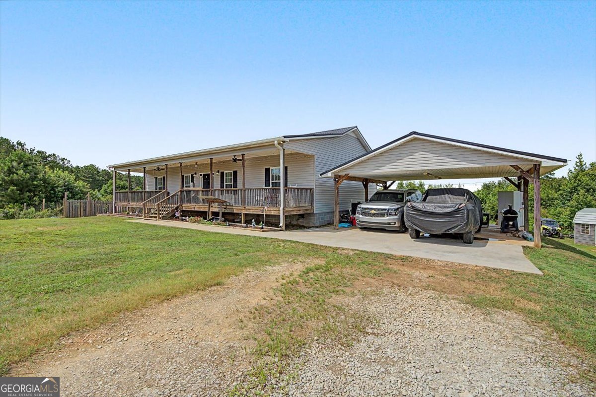147 Edgar Bell Road Tallapoosa, GA 30176 - Photo 17 of 49 a front view of a house with a garden and trees
