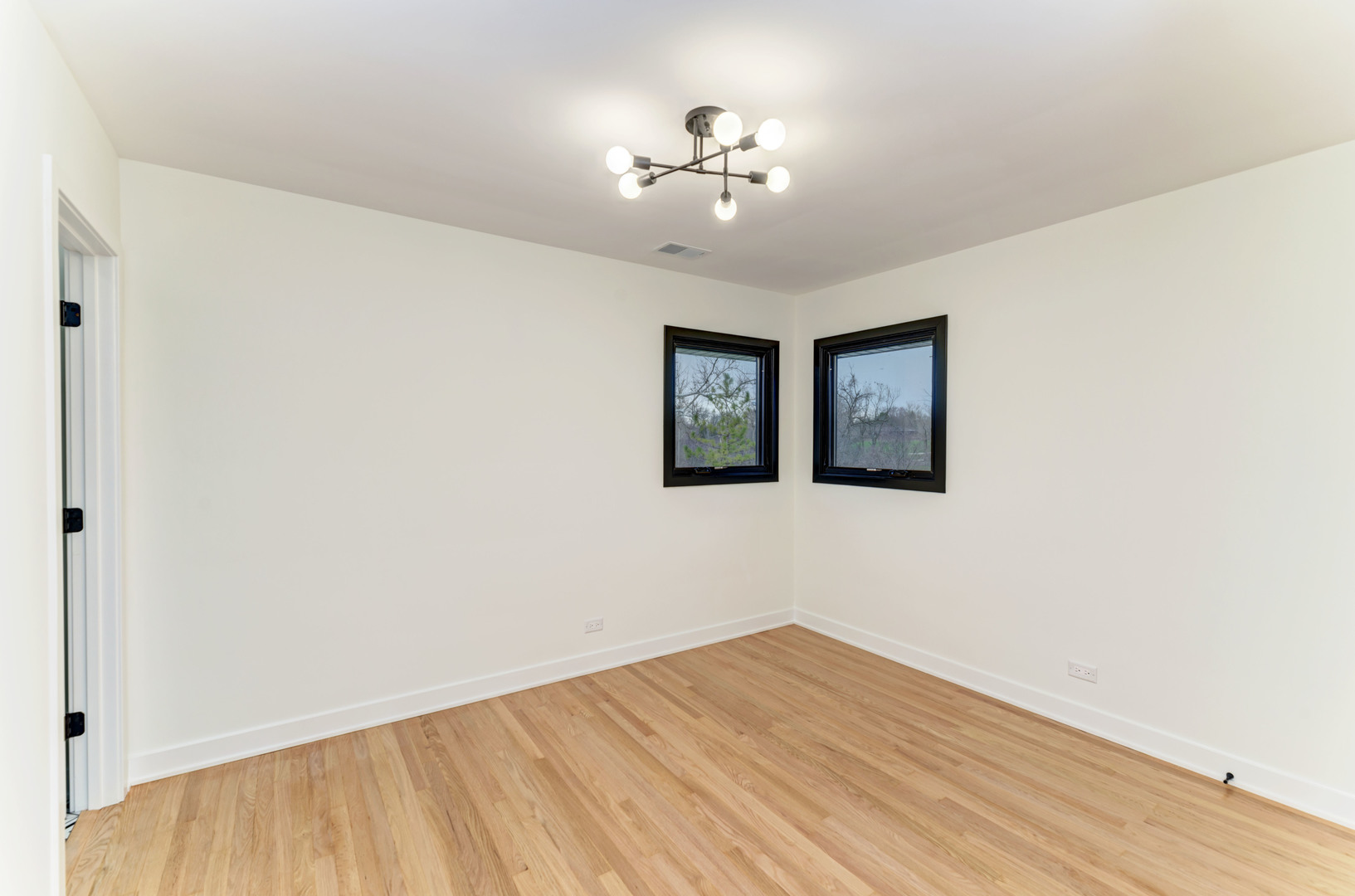 5927 Brookbank Road Downers Grove, IL 60516 - Photo 23 of 38 a view of a room with wooden floor and chandelier fan
