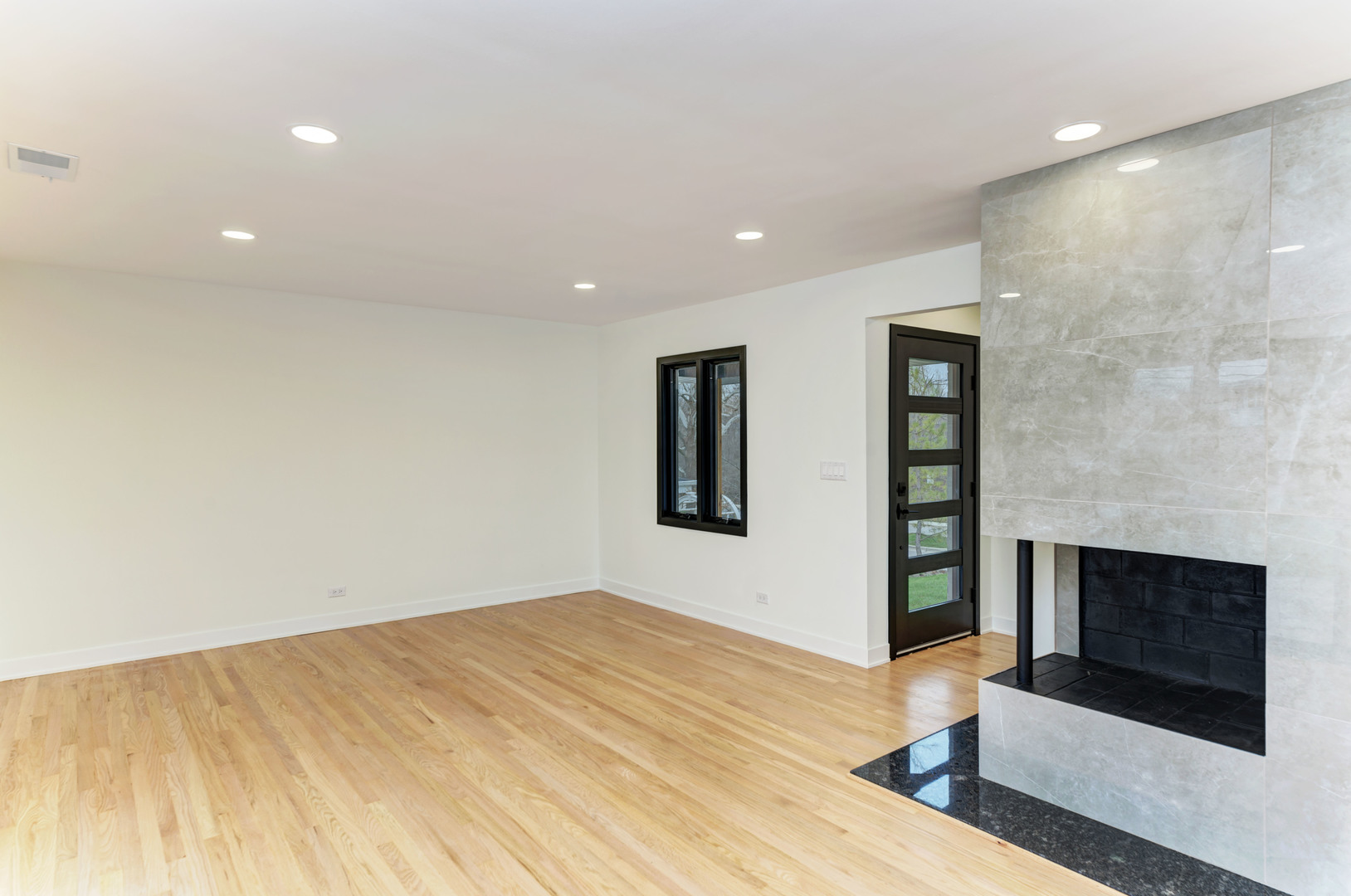 5927 Brookbank Road Downers Grove, IL 60516 - Photo 7 of 38 a view of an empty room with wooden floor and a fireplace