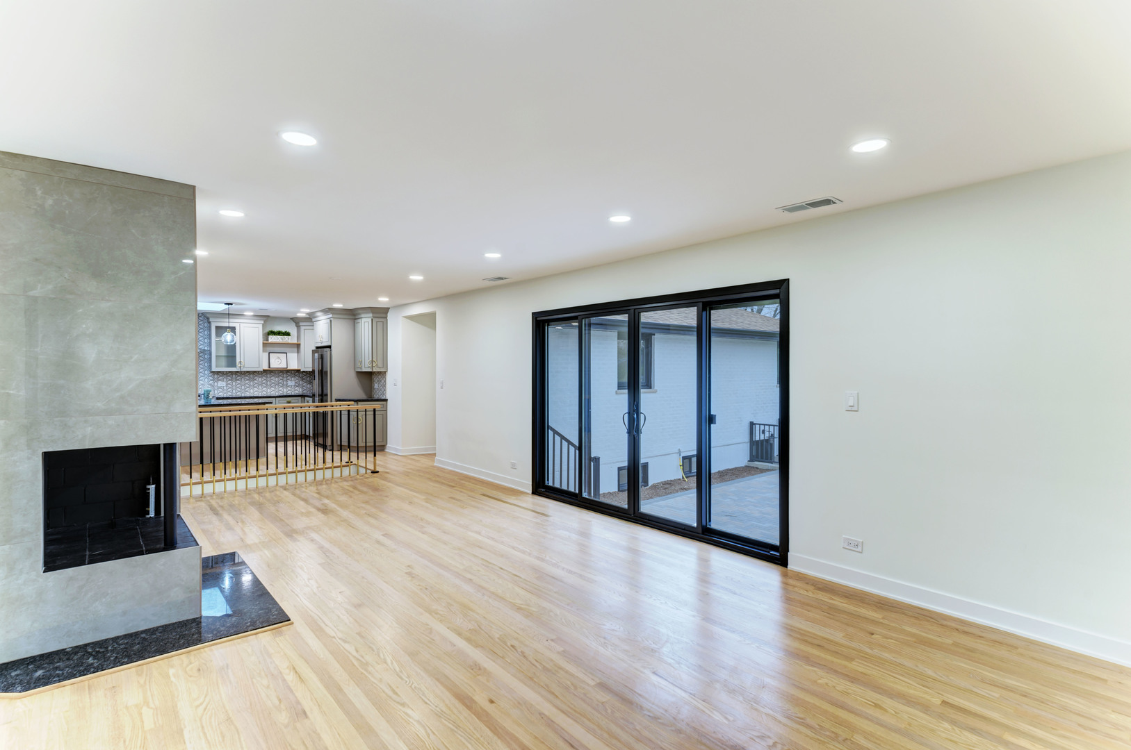 5927 Brookbank Road Downers Grove, IL 60516 - Photo 8 of 38 a view of an empty room with wooden floor and a kitchen