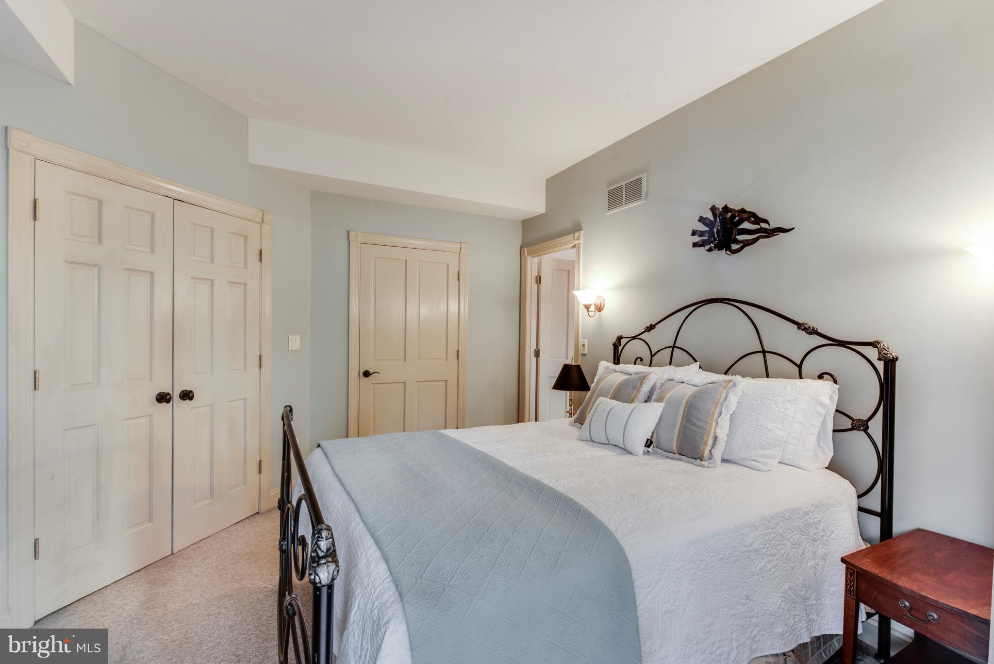 1795 Beachfield Road Annapolis, MD 21409 - Photo 27 of 49 a bedroom with a bed and a chandelier