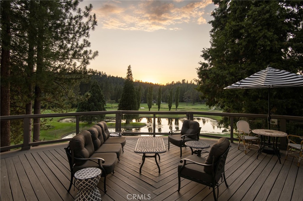 a view of a roof deck with couches and wooden floor