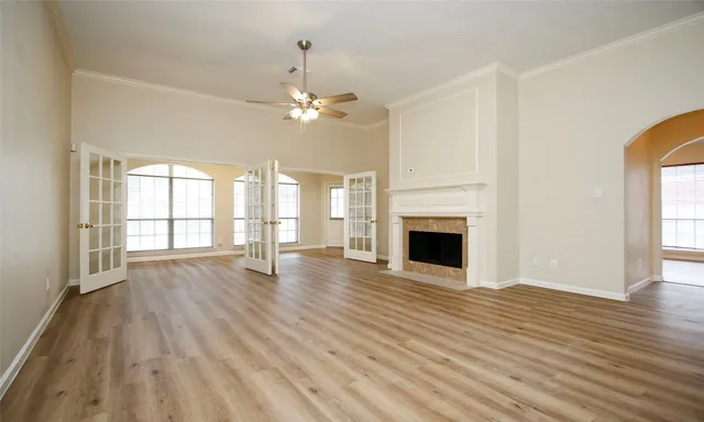 a view of empty room with wooden floor and fireplace