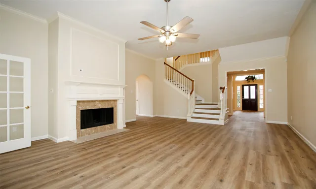 a view of a livingroom with wooden floor and a fireplace