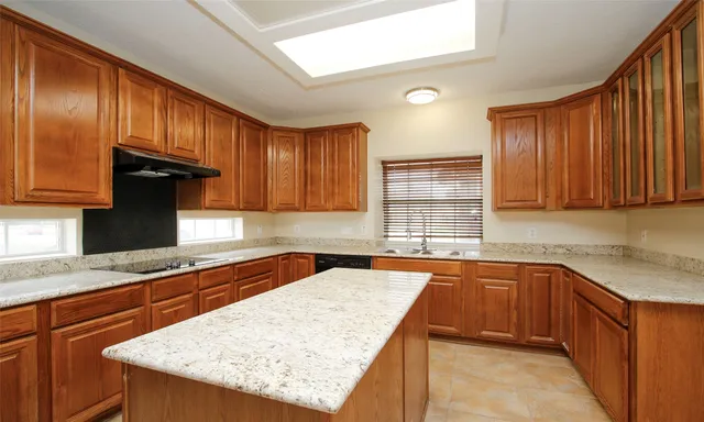 a kitchen with stainless steel appliances granite countertop wooden cabinets a sink and dishwasher