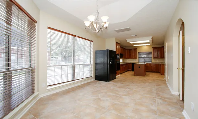 a large room with chandelier and windows