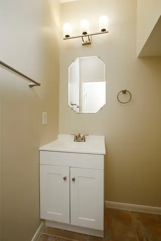 a bathroom with a sink a vanity and a mirror