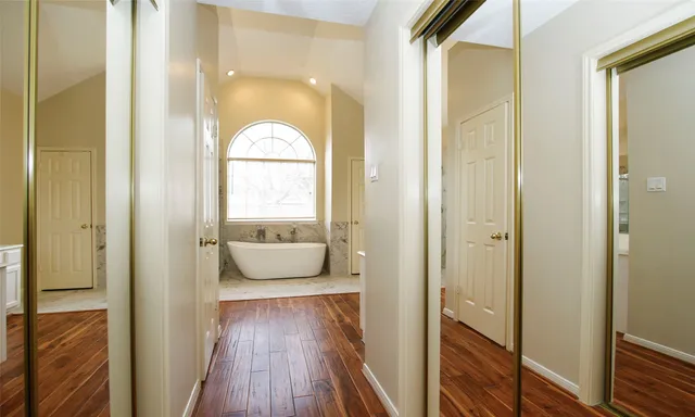 a spacious bathroom with a double vanity sink and a mirror