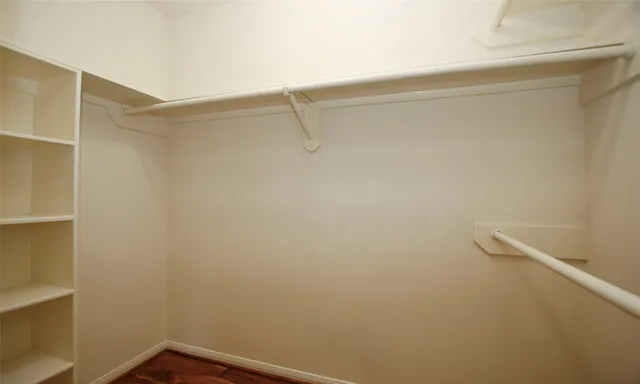 a view of staircase with wooden floor and white walls