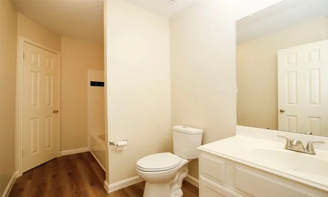 a bathroom with a sink a toilet and a mirror