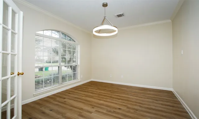 a view of a room with wooden floor and windows