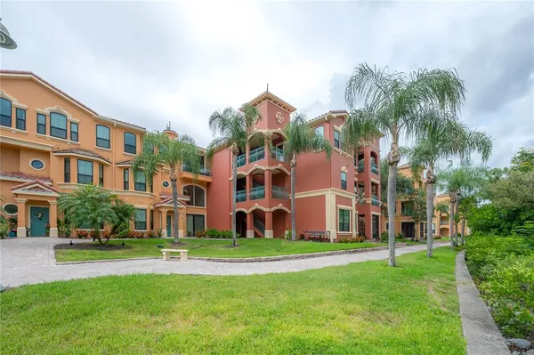 a front view of residential houses with yard and green space