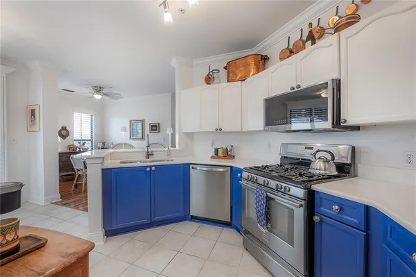 a kitchen with stainless steel appliances granite countertop a sink and a stove