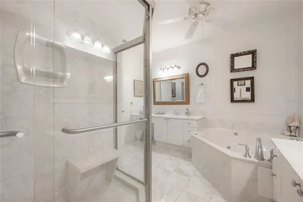 a bathroom with a tub a sink and mirror