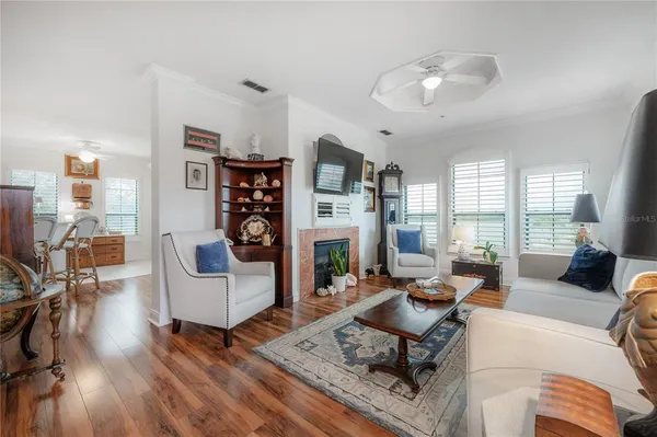 a living room with fireplace furniture and a wooden floor
