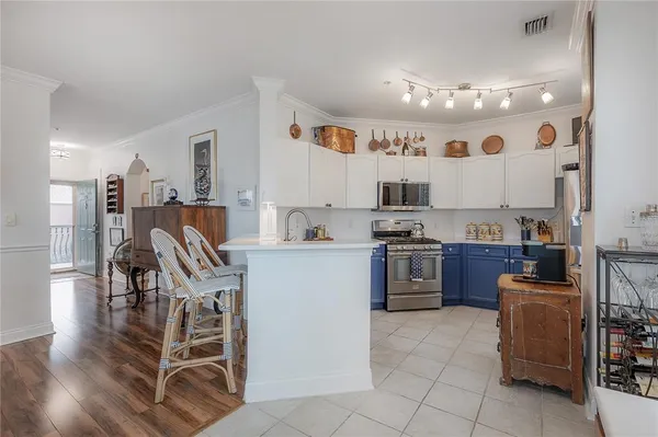 a kitchen with stainless steel appliances granite countertop a stove top oven a sink dishwasher and a refrigerator
