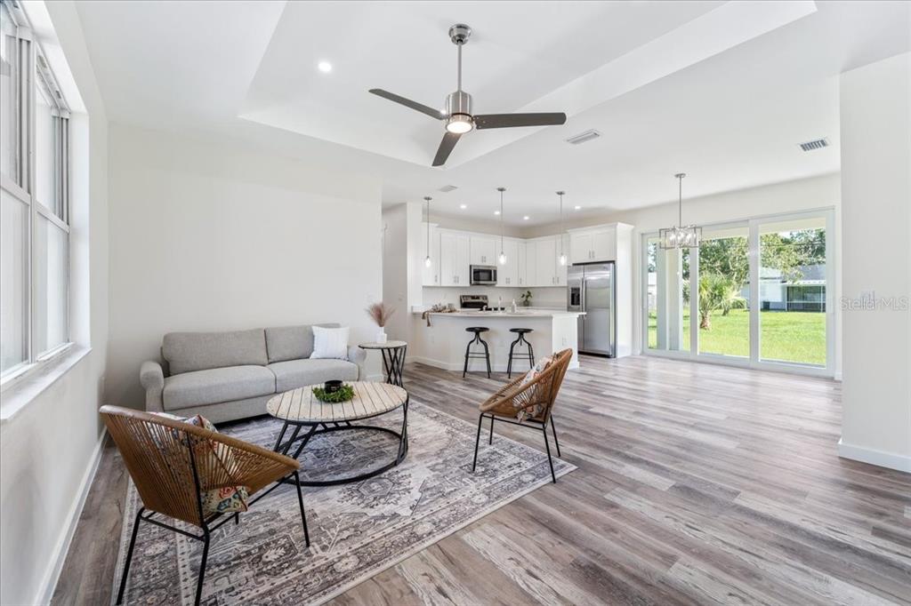 3299 Pinetree Street Port Charlotte, FL 33952 - Photo 2 of 6 a living room with furniture and a large window