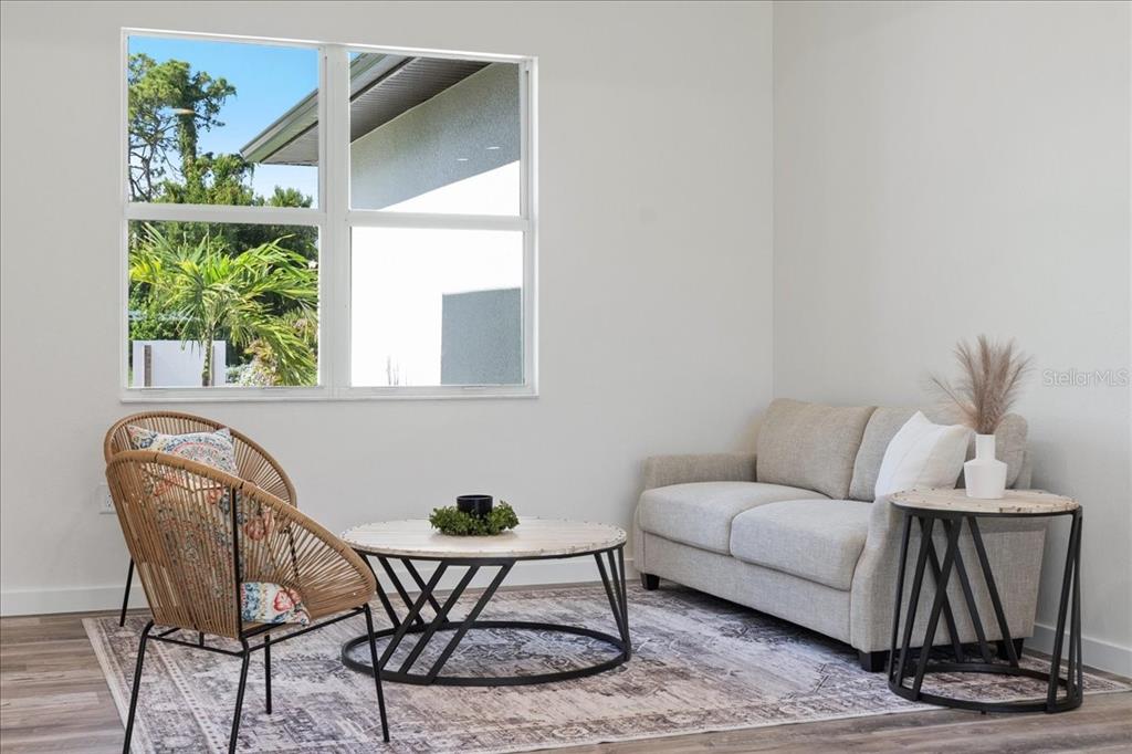 3299 Pinetree Street Port Charlotte, FL 33952 - Photo 3 of 6 a living room with furniture and a potted plant